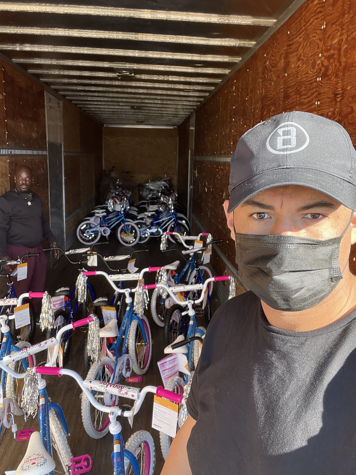 A volunteer with bikes ready to give