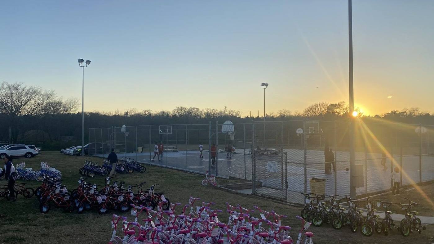 Hundreds of bikes lined up at sunset for the Holly Jolly giveaway
