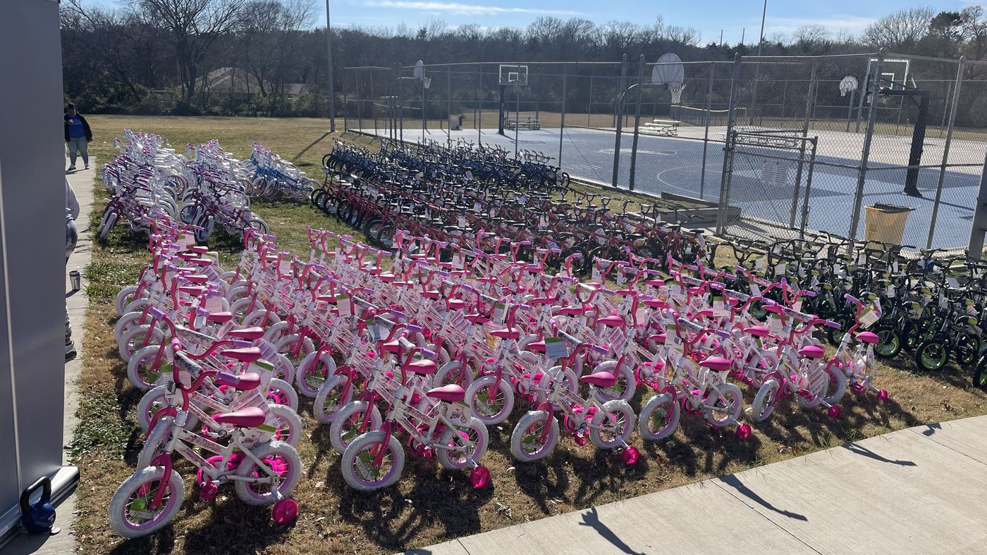 Rows of new bicycles lined up for children at the Holly Jolly giveaway